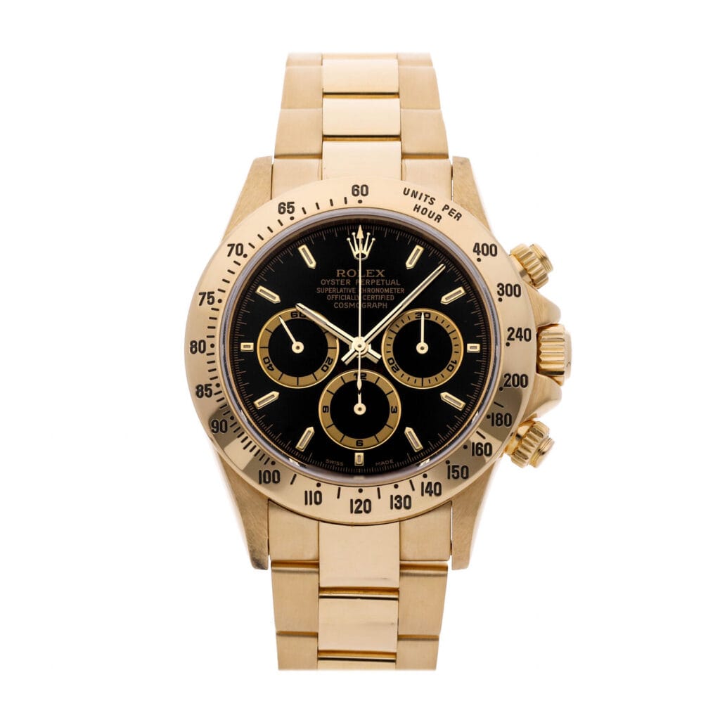 Gold Rolex Cosmograph Daytona with a black dial, three subdials, and a metal link bracelet, shown on a white background.