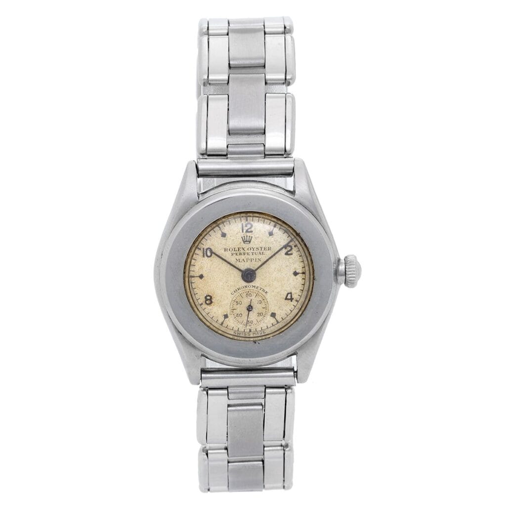 A vintage silver Rolex Oyster Perpetual wristwatch, model 3348, with a round, worn white dial and metal link band, shown from above.