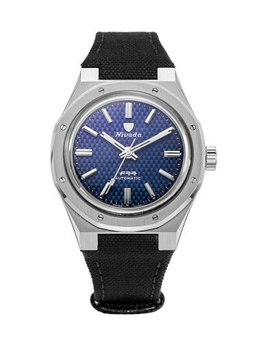 A Nivada Grenchen automatic watch, model F77,68001A77-BC, featuring a blue textured dial, silver markers, and a black fabric strap.