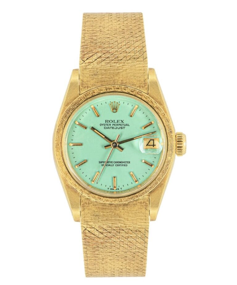 Gold Rolex Datejust wristwatch with a textured band and a mint green dial displaying the date at 3 o’clock.