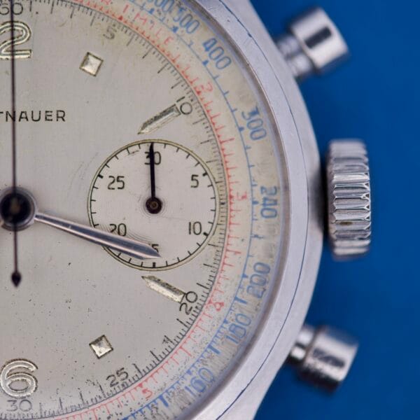 Close-up of a Wittnauer Chronograph Venus 188 watch face with a subdial, silver case, blue background, and featuring the Venus 188 movement.