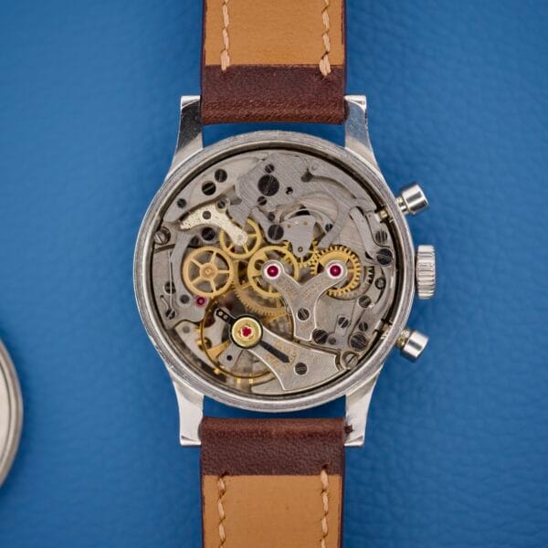 Wittnauer Chronograph Venus 188 wristwatch with a brown leather strap, showcasing exposed gears and intricate inner workings inspired by the classic Venus 188 chronograph movement.