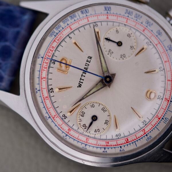 Close-up of the Wittnauer 3256 Chronograph Venus 188, showcasing its vintage white dial with blue and red accents and powered by the iconic Venus 188 movement.
