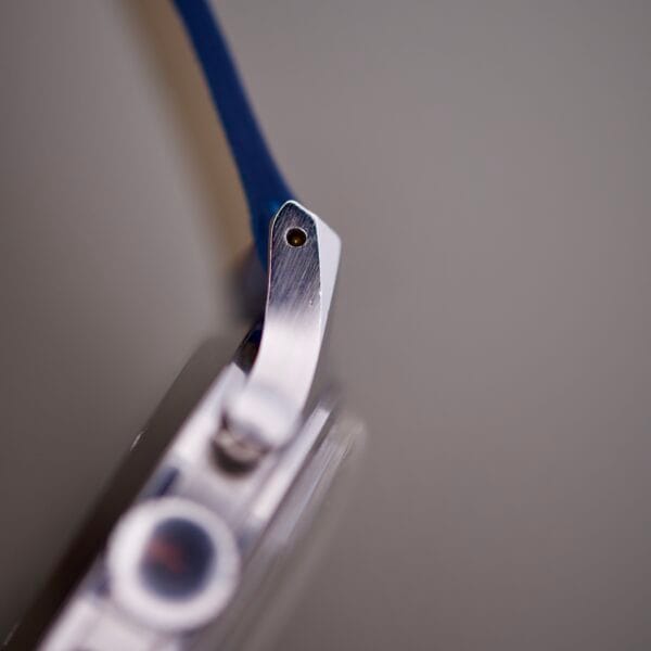 Close-up of the Wittnauer 3256 Chronograph Venus 188 with a silver case and blue strap, set against a blurred grey background.