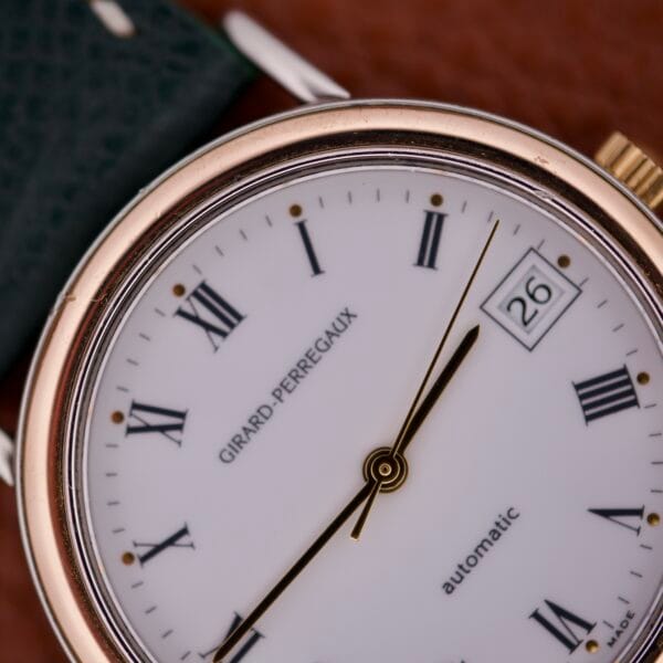 Close-up of the Girard Perregaux Automatic 4797 watch face featuring Roman numerals and the date set to 26.