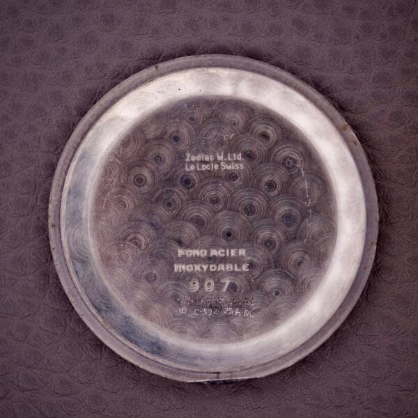 The back of the Zodiac Triple Calendar Moonphase Cal. 12S watch case features engraved text and circular brushing, highlighting its refined triple calendar design.
