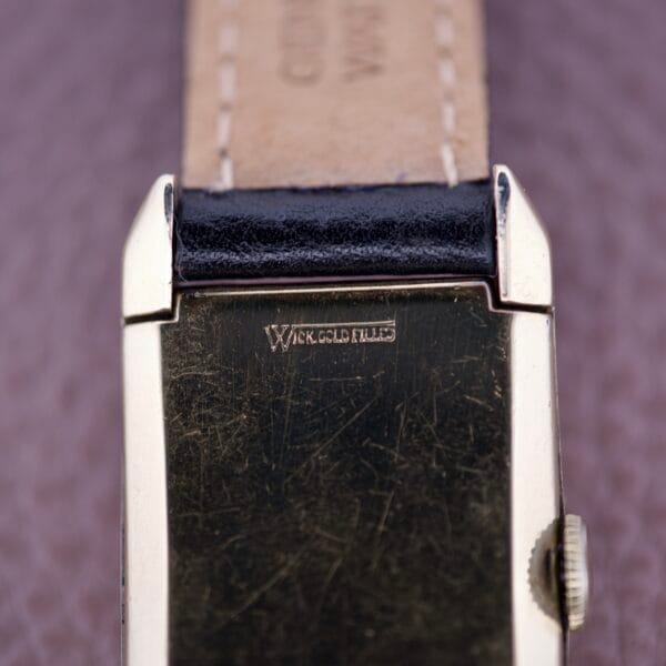 Close-up of the back of a Gruen Curvex Precision Salmon Dial wristwatch engraved with W. K. GOLD FILLED, highlighting the signature craftsmanship of this vintage timepiece.