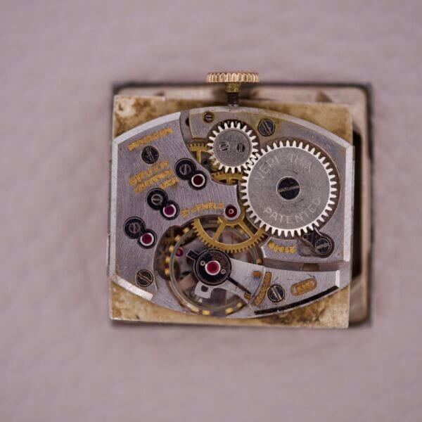 Close-up of the Gruen 21 Precision Tank USA Cal. 335 watch, highlighting its exposed mechanical movement with visible gears and detailed components.