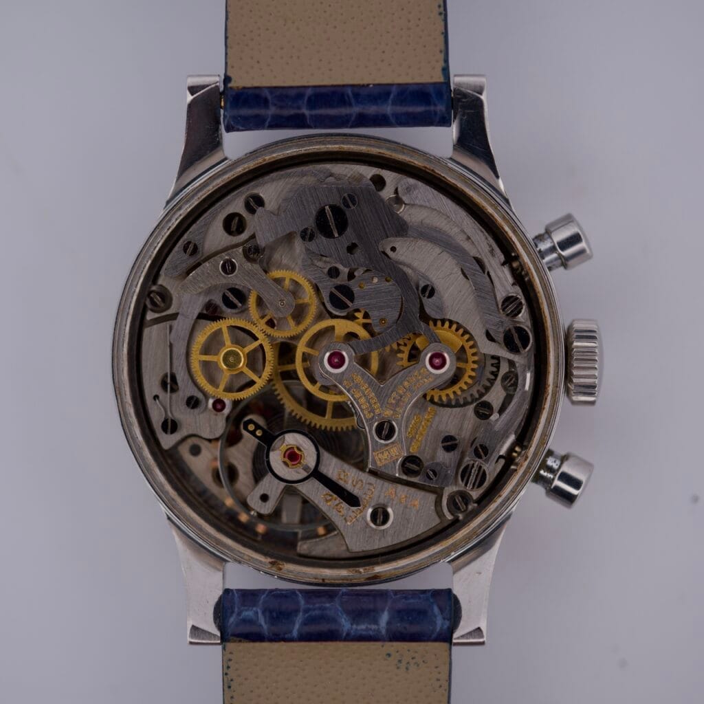 The Wittnauer 3256 Chronograph Venus 188 is a mechanical wristwatch with an exposed caseback that reveals its intricate gears and inner workings.