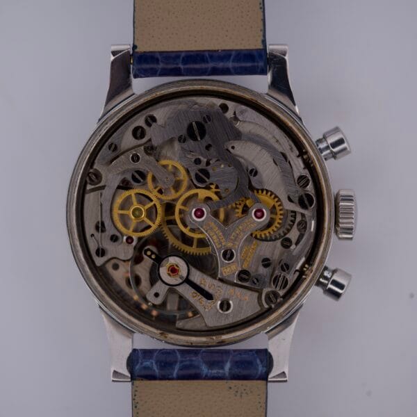 The Wittnauer 3256 Chronograph Venus 188 is a mechanical wristwatch with an exposed caseback that reveals its intricate gears and inner workings.