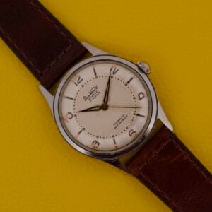 Dom Watch Geneve 17 Jewels Waffle Dial with a brown leather strap, showcased on a yellow textured background.