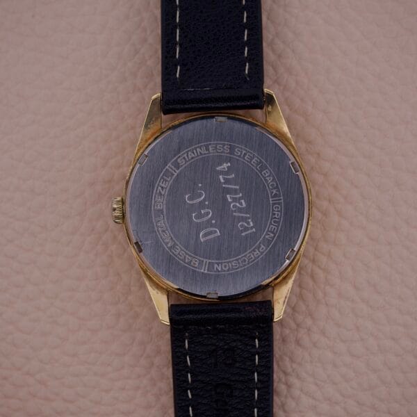 A Gruen Precision 510 Date Masonic Dial watch with a black leather band, engraved on the back with D.G.C. 12/25/74.
