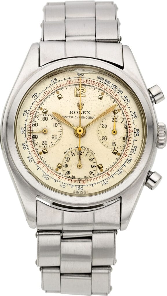 Vintage Rolex Chronograph 6034 watch with a cream dial and stainless steel band, featuring multiple subdials.