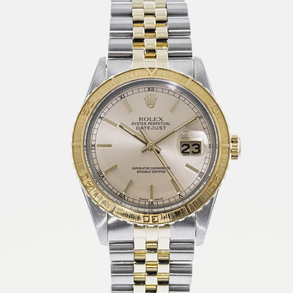 Rolex Datejust Turn-O-Graph watch with a gold and silver two-tone band, silver dial, and date display at 3 o’clock.