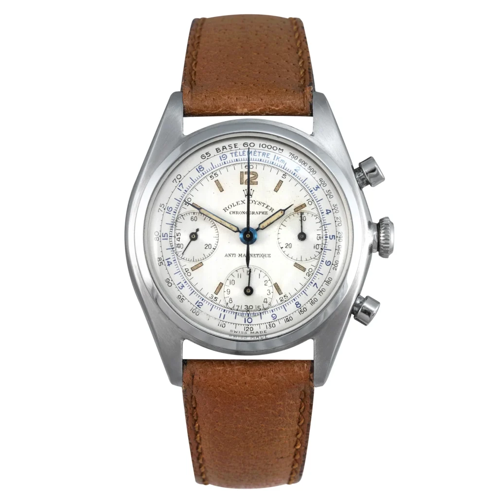 A vintage Rolex Chronograph 4537 watch with a brown leather strap and a white dial featuring multiple subdials.