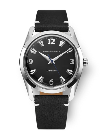 A black Nivada Grenchen Antarctic wristwatch with silver markers, black leather strap, and silver bezel.