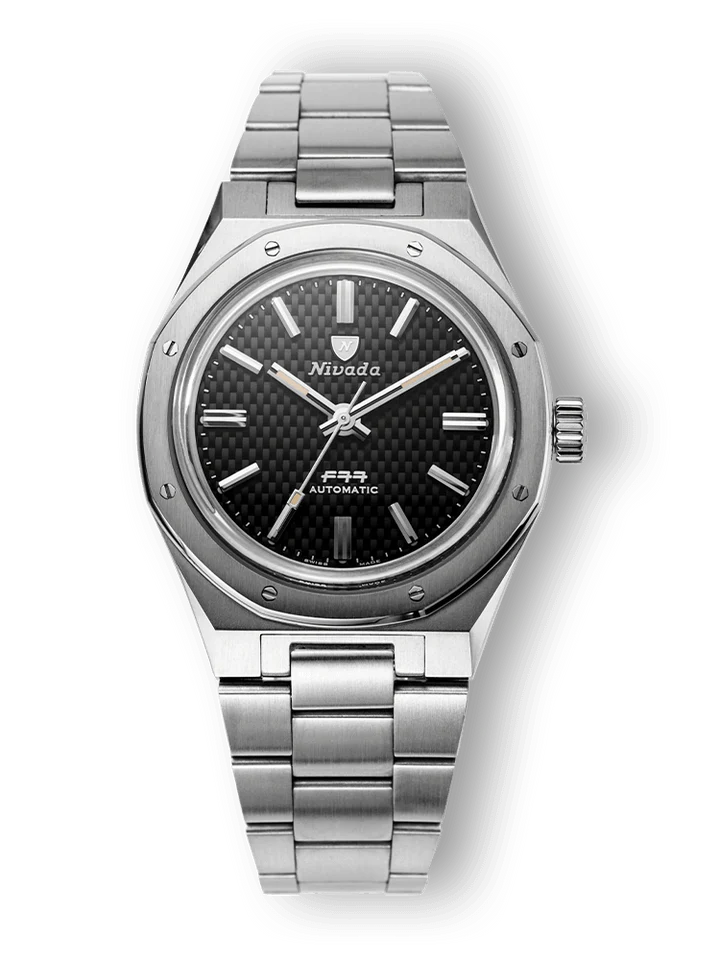 Silver Nivada Grenchen F77 wristwatch with a black textured dial and metal bracelet, shown on a black background.