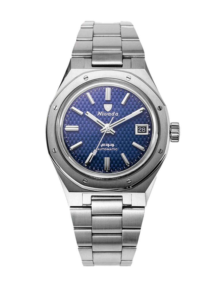 A stainless steel Nivada Grenchen F77 automatic wristwatch with a blue textured dial, date display, and the reference 69001A77.