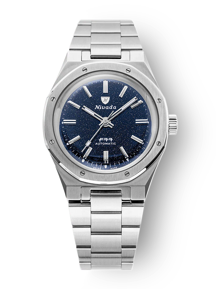 Silver Nivada Grenchen wristwatch, model F77,68010A77, with a blue speckled dial and metal bracelet, viewed from above.