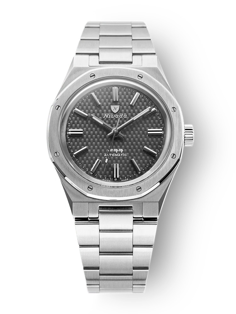 A Nivada Grenchen F77 silver wristwatch with a metal band and a dark textured face elegantly displaying the time.