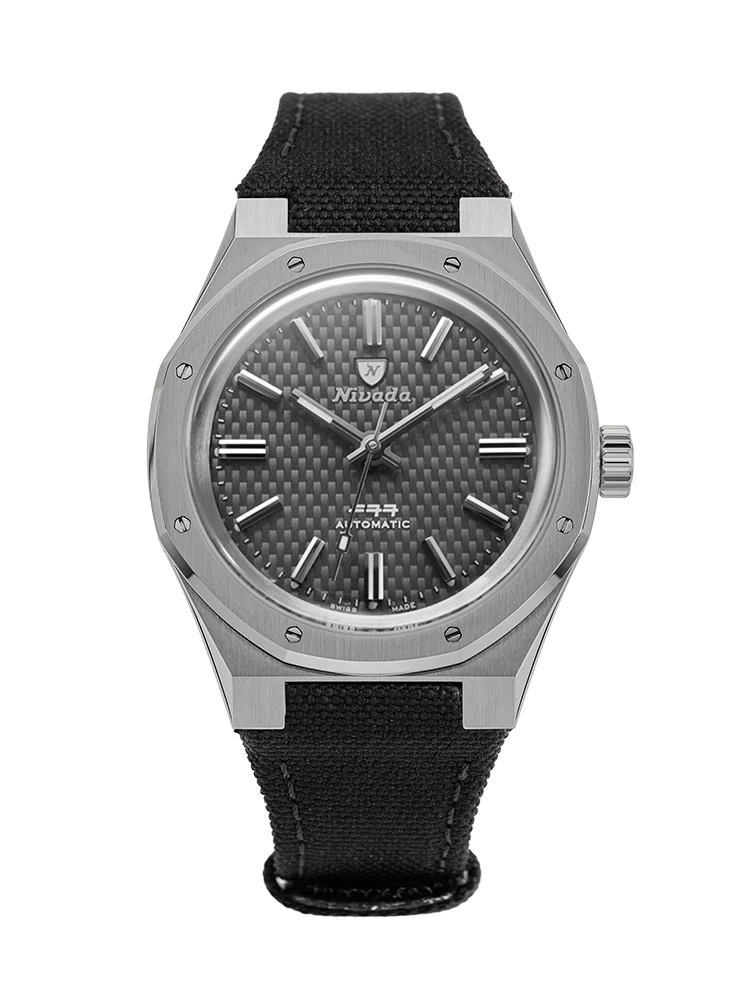 A Nivada Grenchen F77 silver wristwatch with a carbon fiber dial and black fabric strap, viewed from the front. Model: 68006A77-BC.