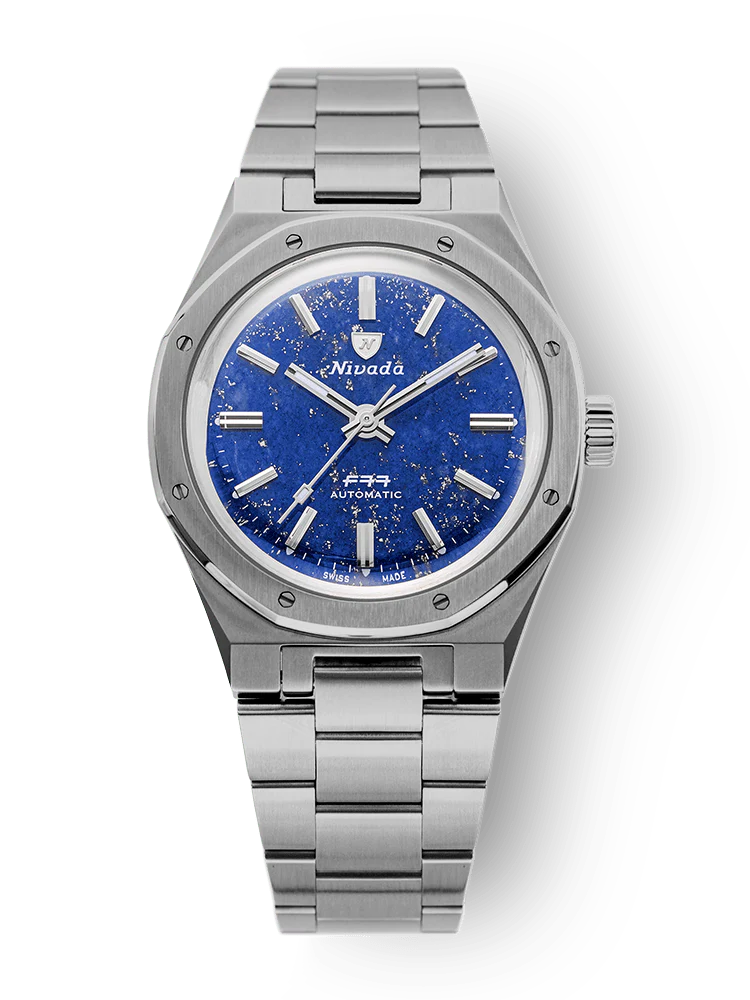 A Nivada Grenchen silver wristwatch, model 68017A77, features a blue, star-speckled dial with silver markers on a sleek metal bracelet.