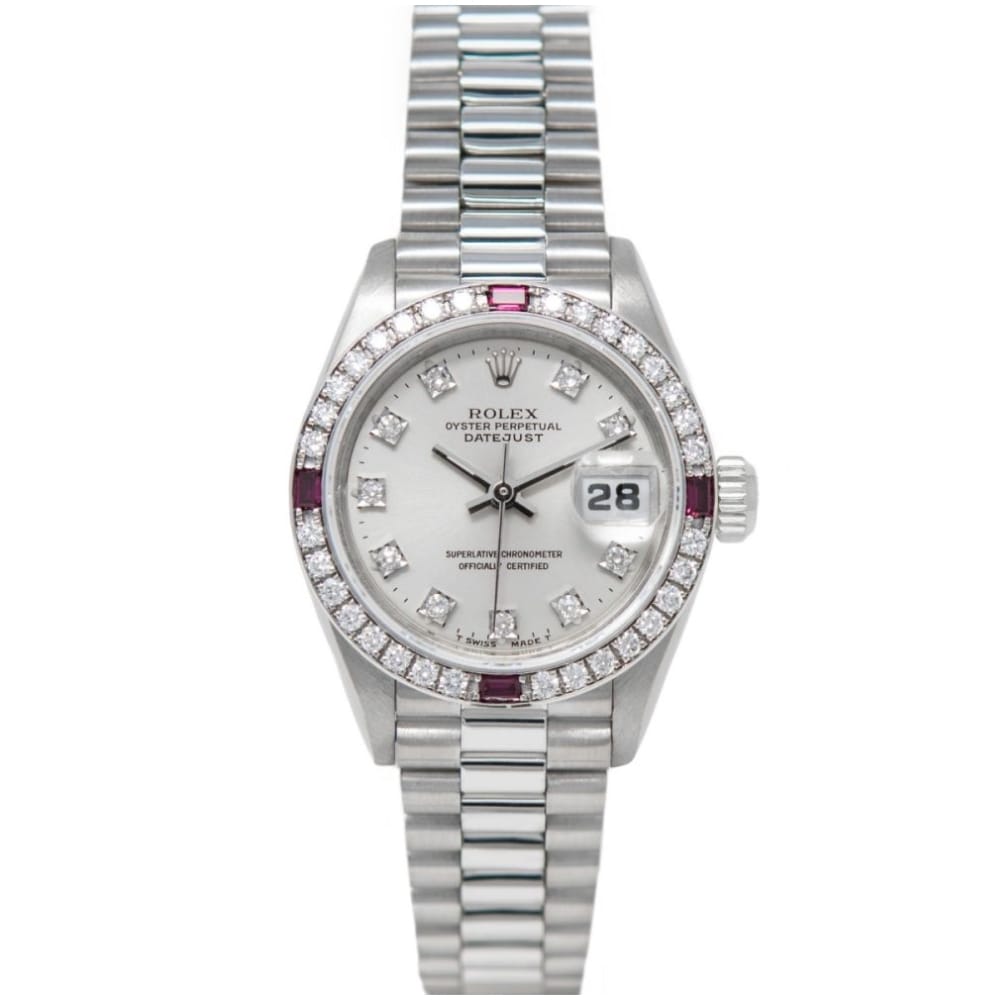 A silver Rolex Datejust 69069 watch with diamond markers, a diamond bezel, and a metal bracelet band.