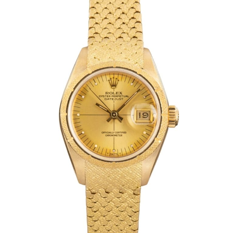 Gold Rolex Datejust 69008 watch featuring a gold dial, gold mesh strap, and a date window at 3 o’clock.
