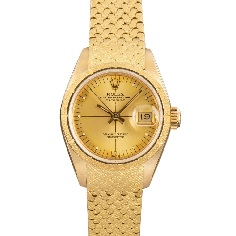 Gold Rolex Datejust 69008 watch featuring a gold dial, gold mesh strap, and a date window at 3 o’clock.