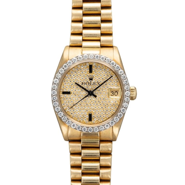 Gold Rolex Datejust 6828 watch with a diamond-encrusted face and bezel, featuring a date display and classic gold link bracelet.