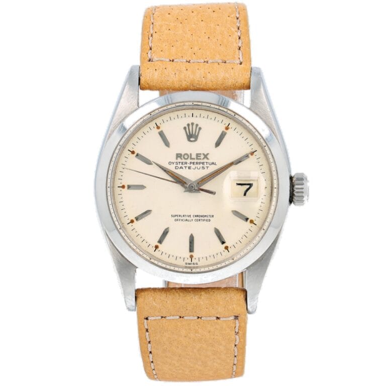 A Rolex Datejust 6604 watch with a beige leather strap and a white dial displaying the date at 3 oclock.