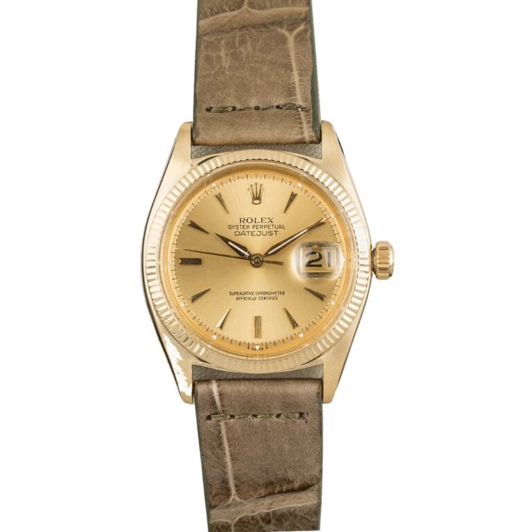 Gold Rolex Datejust 6605 watch with a beige dial and date display, brown leather strap, and fluted bezel.