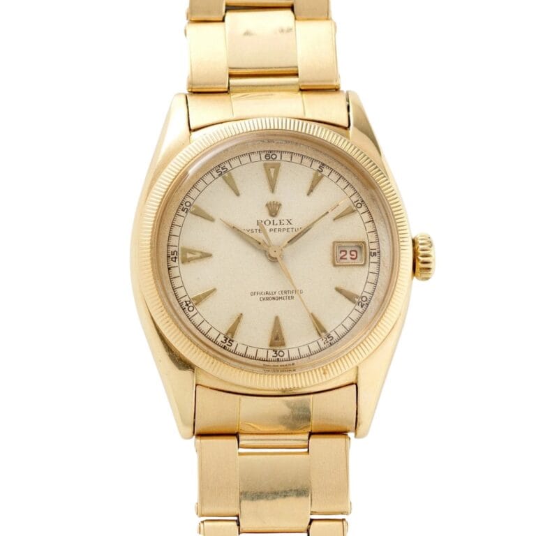 Gold Rolex Datejust 6155 wristwatch featuring a white dial, gold indices, and a date window displaying the number 29.