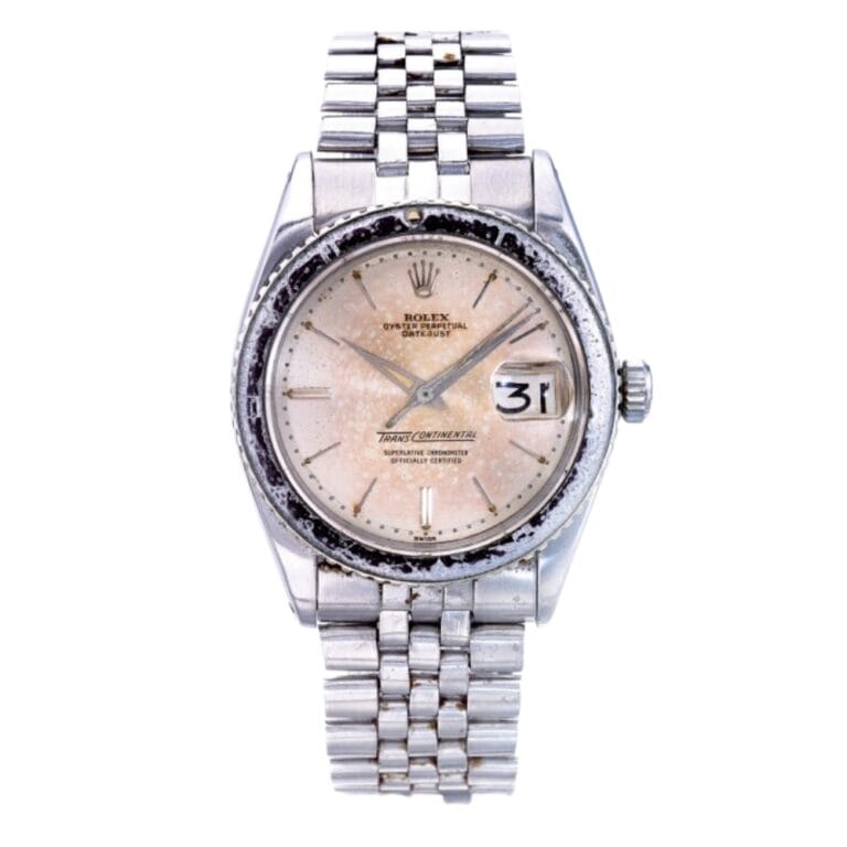 Vintage silver Rolex Datejust 6602 watch featuring a white dial, metal bracelet, and a visible date display.
