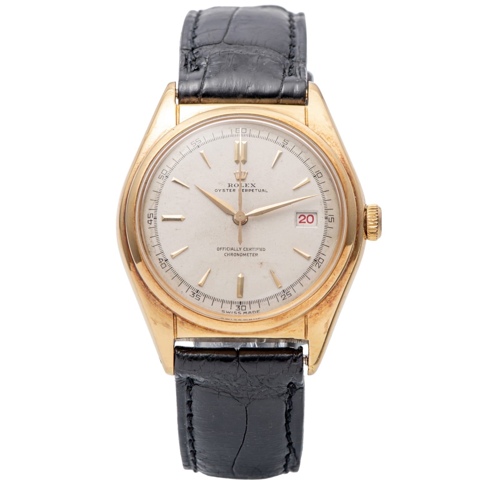A gold Rolex Datejust wristwatch with a black leather strap and a date display showing the number 28.
