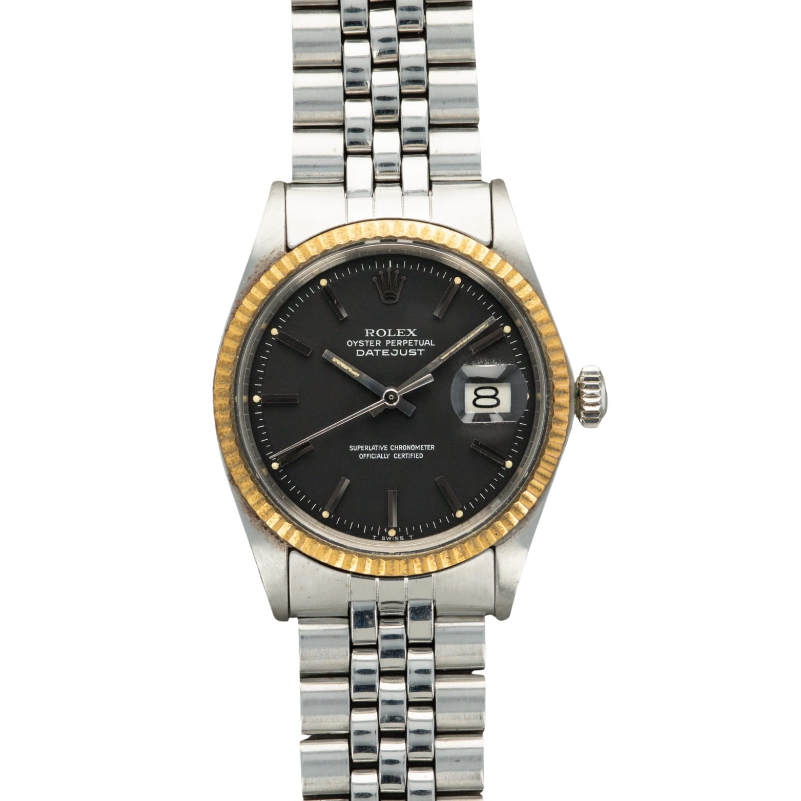 A Rolex Datejust 1601 watch with a black dial, gold fluted bezel, and silver jubilee bracelet, displaying the date.