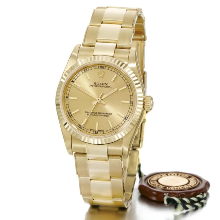 A gold Rolex Datejust Oyster Perpetual wristwatch, reference 77518, with a matching gold bracelet and tag.