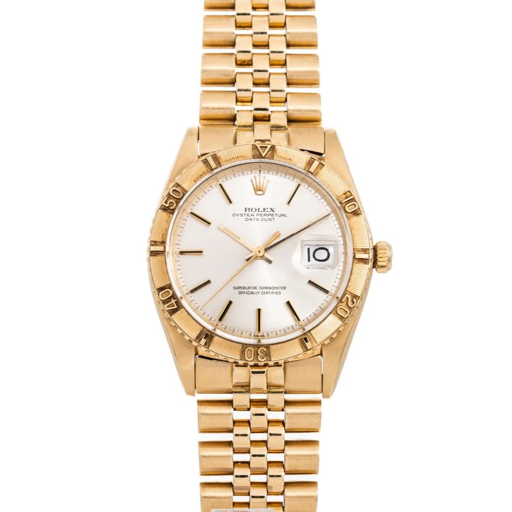 Gold Rolex Datejust wristwatch with a white dial, date window, and metal link band, shown on a white background.
