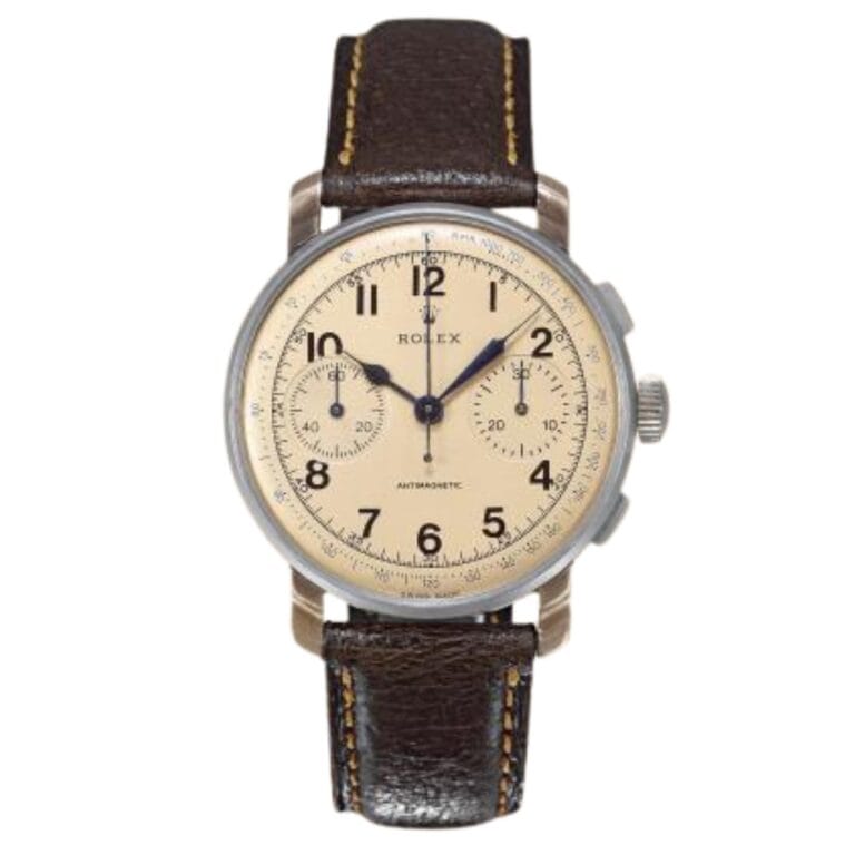A vintage Rolex chronograph watch with a beige dial, black numerals, and a brown leather strap.