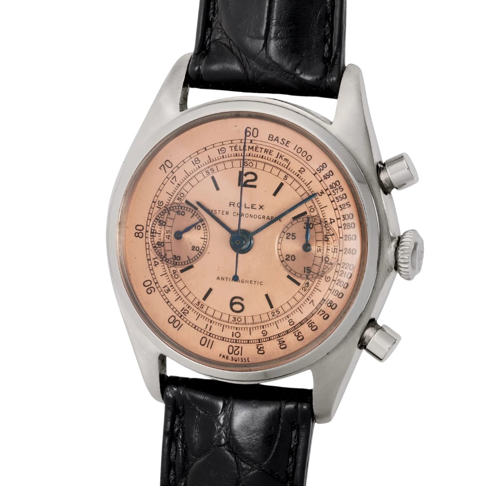 Vintage Rolex Chronograph 3997 watch with a salmon dial, black leather strap, and two side buttons.