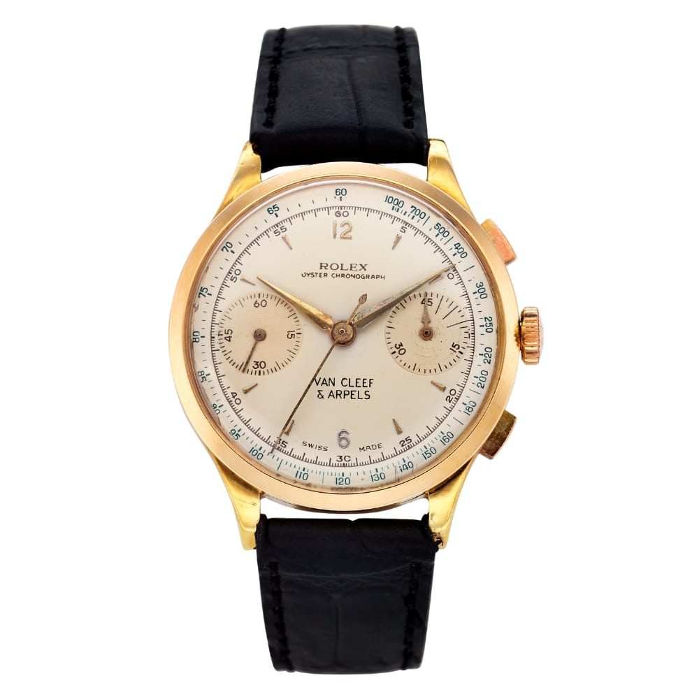 Gold Rolex chronograph watch with black leather strap, two subdials, and Van Cleef & Arpels on the face.