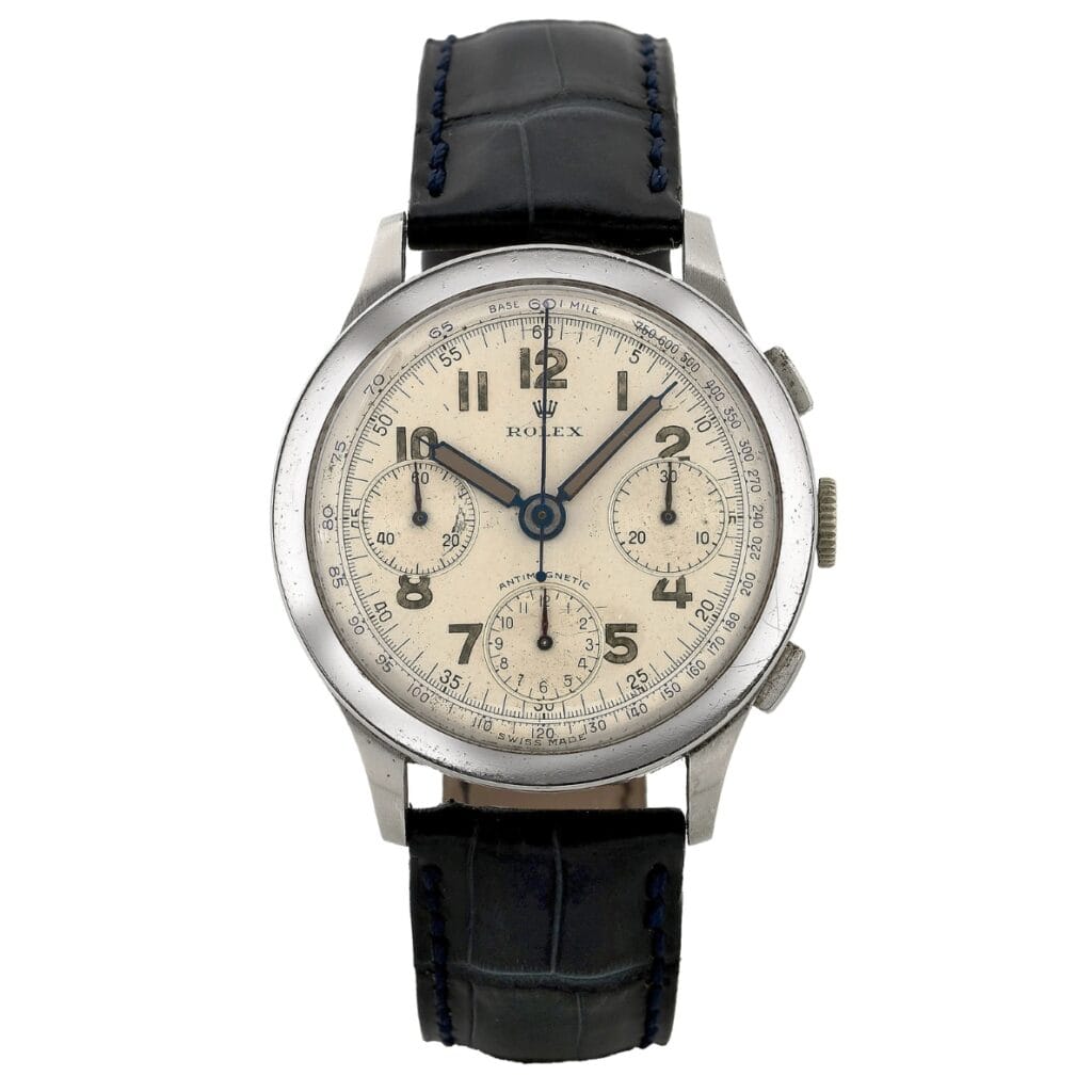 Vintage Rolex 3330 chronograph watch featuring a cream dial, three subdials, and a black leather strap.