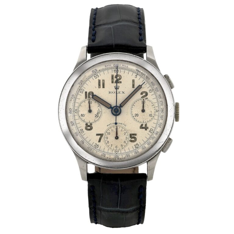 Vintage Rolex 3330 chronograph watch featuring a cream dial, three subdials, and a black leather strap.