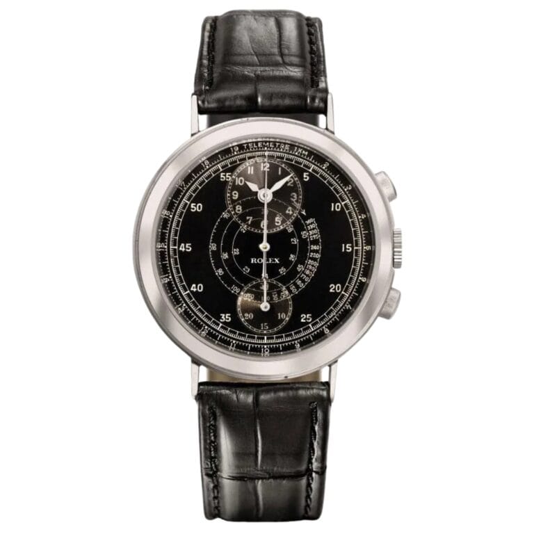 A vintage Rolex Chronograph 2737 with a black leather strap and a detailed black dial featuring multiple subdials.