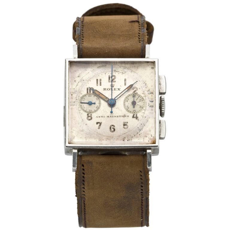 Vintage square Rolex watch with a worn brown leather band, two small subdials on the face, and classic chronograph detailing.