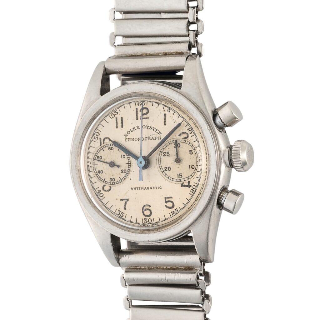 Vintage Rolex Chronograph 3481 wristwatch featuring a metal band and two subdials on a cream-colored face.
