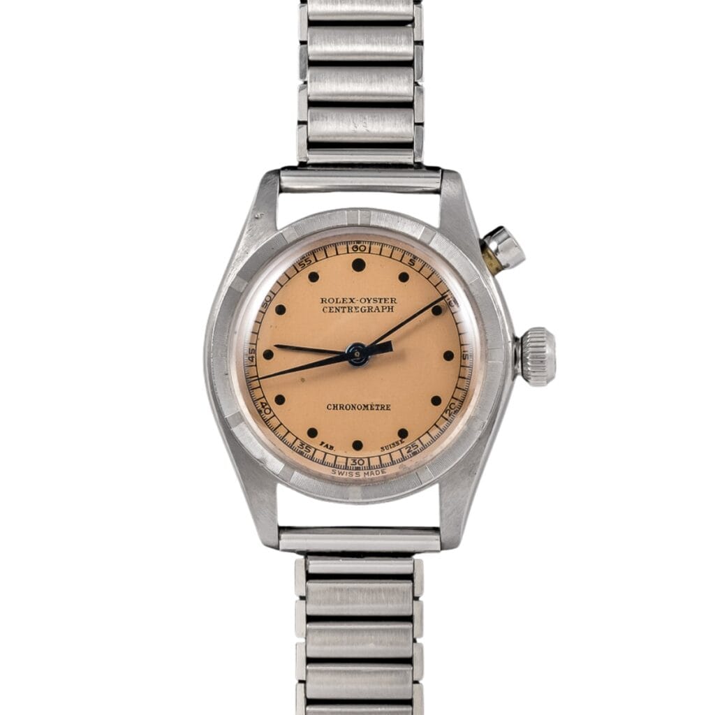 A vintage Rolex 3462 Oyster Chronograph watch featuring a salmon dial and metal bracelet.