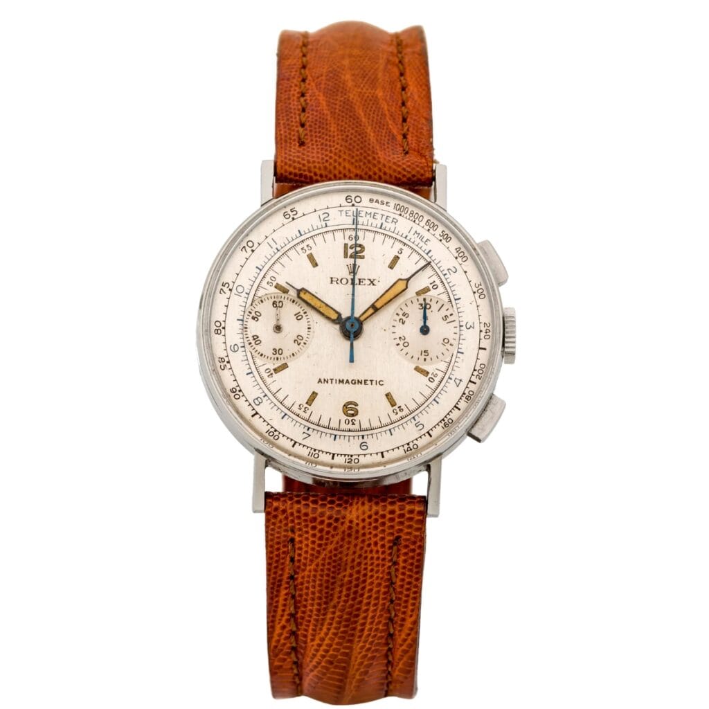 Vintage Rolex Chronograph 3484 watch with a brown leather strap and a white dial featuring multiple subdials and markers.