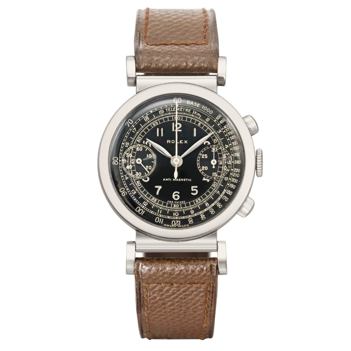 A vintage Rolex Chronograph 2918 watch with a black dial, silver case, and brown leather strap.