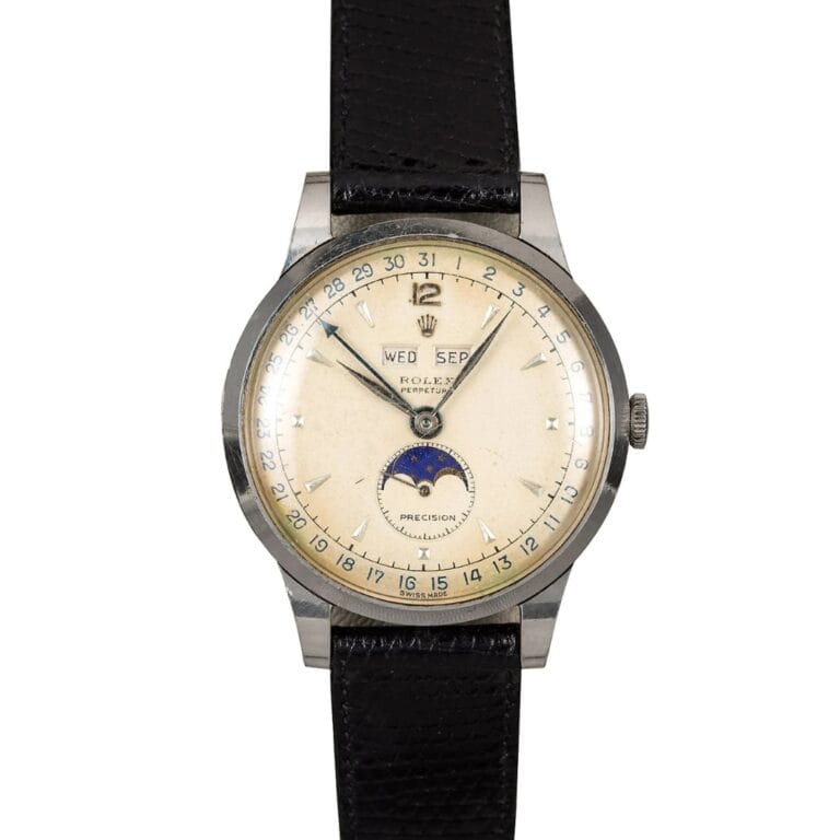 Vintage Rolex Moonphase watch featuring a cream dial, black leather strap, and elegant moonphase and calendar displays.